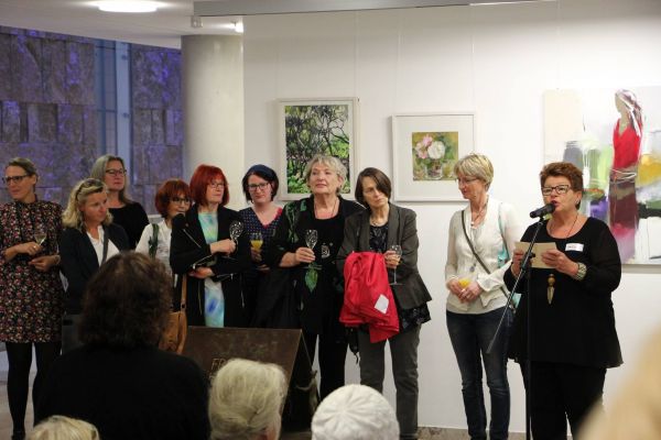 Eine FhF-Mitarbeiterin im Kreise einiger Künstlerinnen bei der Ausstellungseröffnung zur Online-Kunstversteigerung UNSCHLAGBAR im Haus der Kath. Kirche am 16.10.2017